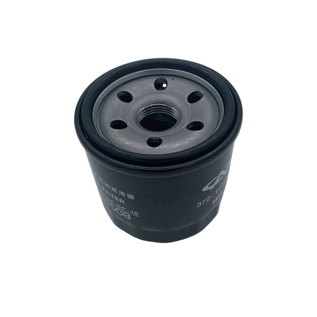 A black cylindrical automotive oil filter with a threaded center and white printed specifications, photographed on a light gray surface. 0812-110 - FILTER, OIL - ARCTIC CAT PARTS