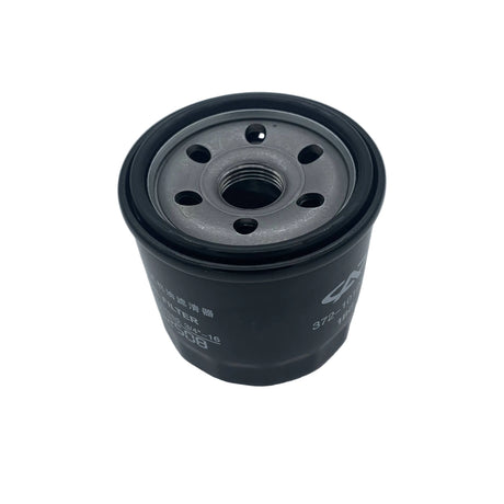 A black cylindrical automotive oil filter with a threaded center and white printed specifications, photographed on a light gray surface. 0812-110 - FILTER, OIL - ARCTIC CAT PARTS
