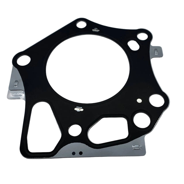 A black engine head gasket with silver metal tabs, photographed on a light gray background. 11004-0792 - GASKET-HEAD - KAWASAKI ENGINE PARTS