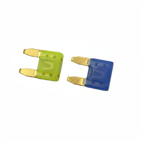 Two small fuse-like components on a light gray surface, one bright yellow and one blue, each with exposed metal terminals. 593901 - FUSE - BRIGGS &amp; STRATTON PARTS