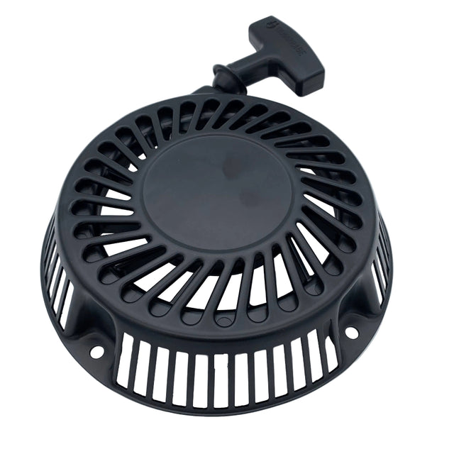 A black circular plastic cover with radial slotted vents and a T-shaped handle on top, photographed on a plain light background. 692102 - STARTER-REWIND - BRIGGS & STRATTON PARTS
