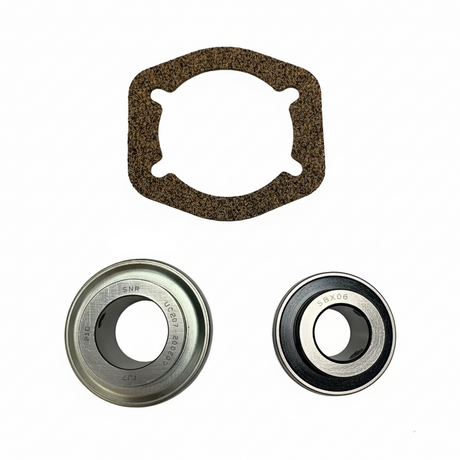 A mechanical bearing kit on a white background, including a brown textured gasket, a silver metal bearing, a black and silver bearing. BK-200HDB-AM - HD 1.25" BEARING KIT - MIDDLE (2010-2017) - AFTERMARKET